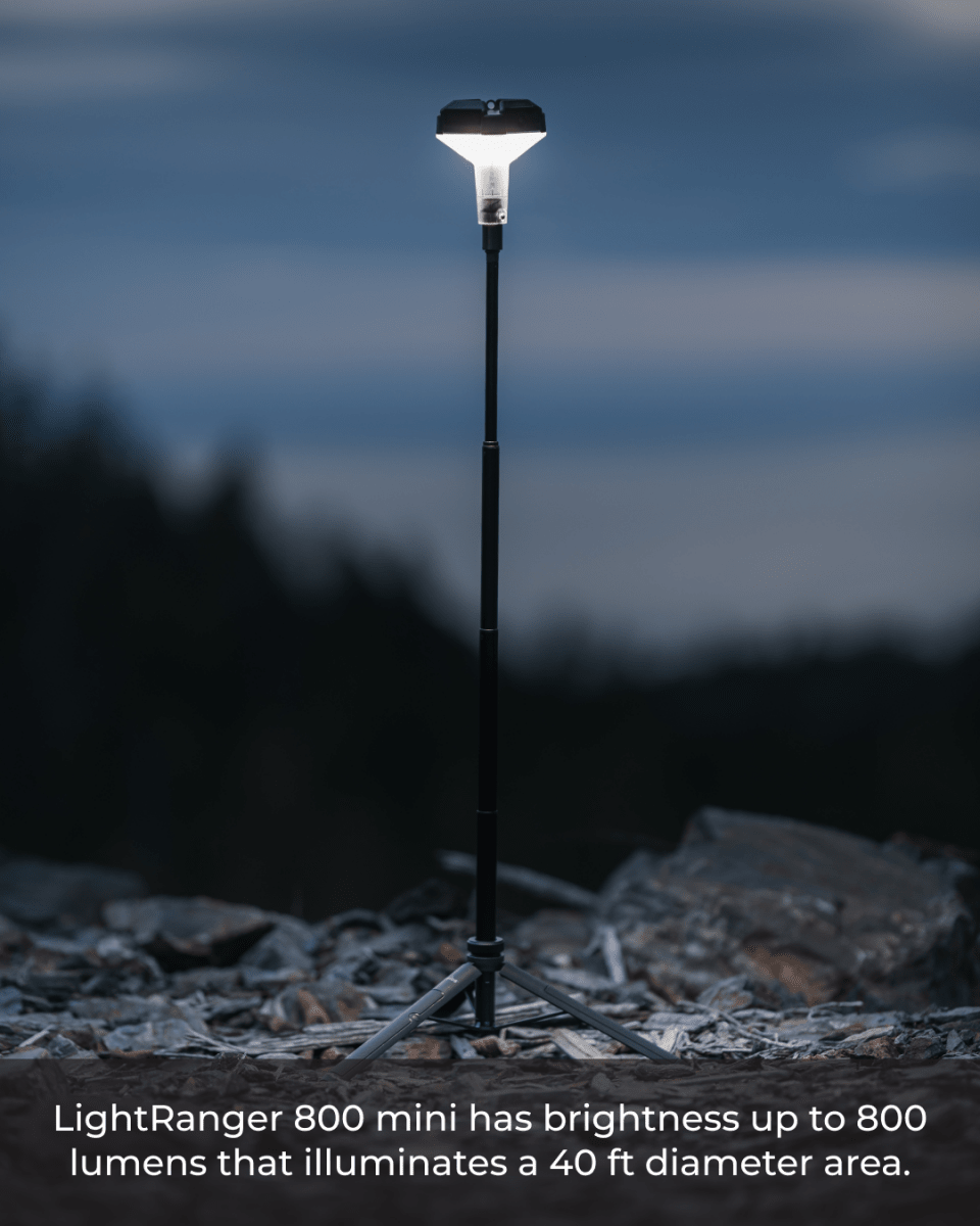 A LightRanger 800 mini lantern is set up on a rocky surface, featuring a telescoping design that allows it to extend upward.